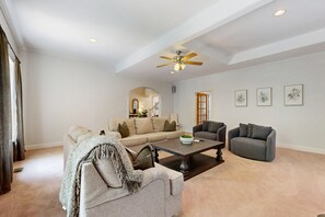 A spacious living room with a ceiling fan, a coffee table, and two sofas. - Family-friendly Waterfront Retreat With Game Room, EV Charger, & More! (Bumpass)