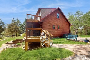 A log cabin with a wooden deck, a staircase, and a bench. - Lakefront House W/waterslide, hot Tub, Game Room, & Wood Fireplace (Mineral)