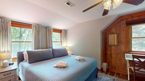 A bedroom with a bed, a desk, a chair, a ceiling fan, and a window with curtains. - Lakefront House W/waterslide, hot Tub, Game Room, & Wood Fireplace (Mineral)