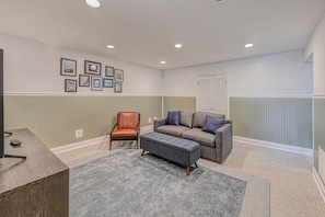 A room with a desk, a cushioned bench, a sofa, and a chair. - Stunning Lakefront House With View, Free Wifi and Secluded Swimming Area (Spotsylvania)