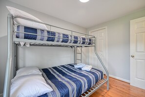 A bunk bed with a striped bedspread, a white pillow, and a metal ladder. - Quiet Lake Home With two Kayaks, Furnished Deck, Grill & Fast Wifi - Dogs OK (Mineral)