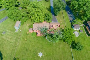 A large, single-story brick house with a spacious backyard, surrounded by trees and a paved driveway. - Quiet Lake Home With two Kayaks, Furnished Deck, Grill & Fast Wifi - Dogs OK (Mineral)