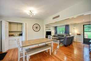 A spacious living area with a dining table, sofa, and kitchen in the background. - Quiet Lake Home With two Kayaks, Furnished Deck, Grill & Fast Wifi - Dogs OK (Mineral)