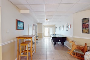 A hallway with a pool table, a wooden rocking horse, and framed artwork on the walls. - Lakefront Retreat With Views, hot Tub, Kid's Play Area, Dock & Fiber Internet (Mineral)