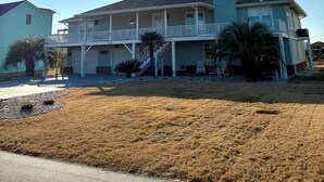 A two-story house with a balcony, a garage, and a driveway. - Spacious 3-bedroom, 2-bath canal home located with Canal access and Waterway views. (Supply)