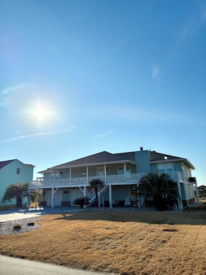 A two-story house with a balcony, a garage, and a driveway. - Spacious 3-bedroom, 2-bath canal home located with Canal access and Waterway views. (Supply)