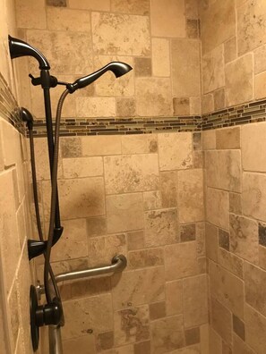 A shower with a handheld showerhead and a handheld scrubber. - Elle & Becks loft Suite (Galena)