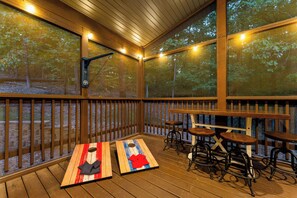 An outdoor deck with wooden railings, tables, and chairs. - 2 min drive to Silver Dollar City, 4BR/4BA Family Friendly Retreat (Branson)