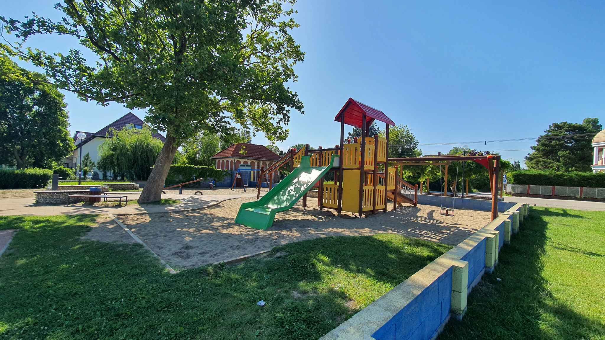 A playground with a slide and climbing structures.
