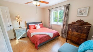 A bedroom with a bed, nightstand, dresser, and a ceiling fan. - Convenient & Modern 2 Bed Apt Free Wi-Fi & Parking (Pikeville)