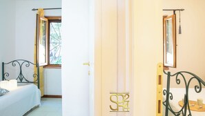 Quarto com uma cama, janela e porta.