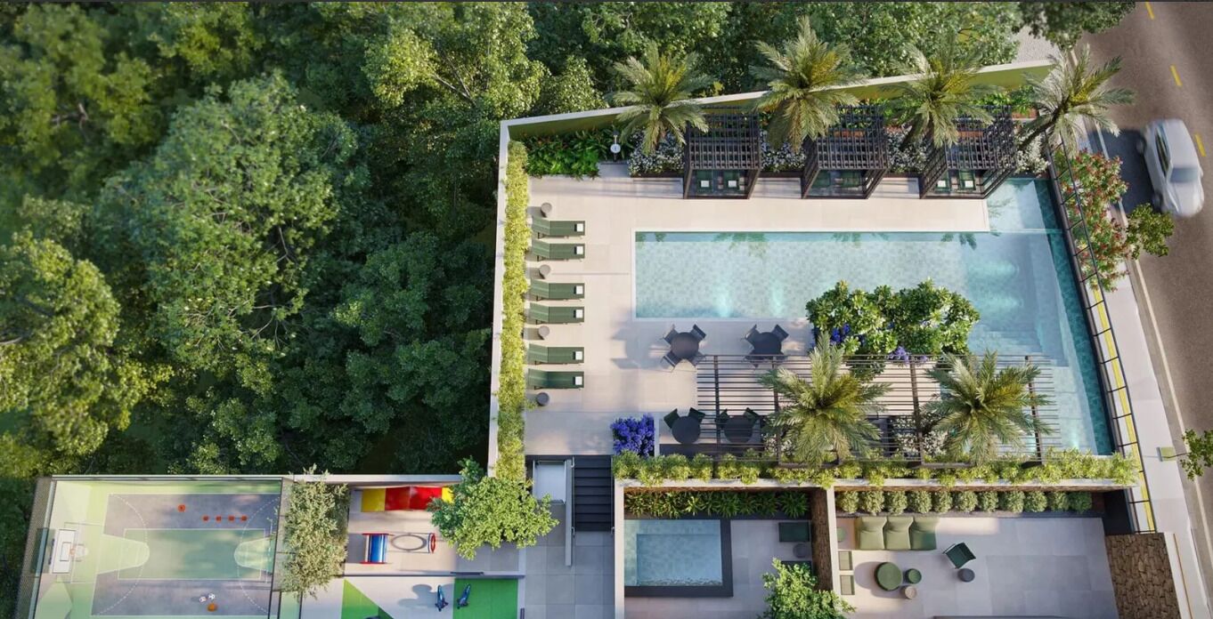 An aerial view of a resort with a swimming pool, lounge area, and a children's play area.