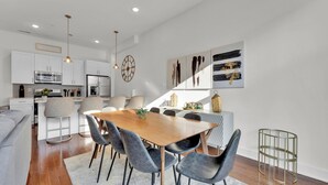 A modern kitchen with white cabinets, stainless steel appliances, and pendant lighting. - Apartmint at Germantown Ave Philadelphia (Philadelphia)