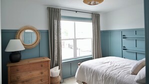 A bedroom with a bed, dresser, mirror, and window with curtains. - Rooftop Bay Views - Downtown Lakehouse Sleeps 8 (Sandusky)