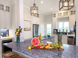 Large gourmet kitchen with oversized island, pendant lighting, and open-concept layout ideal for entertaining during beach vacations. - 2nd Row Beach | Hot Tub & Game Room | Sleeps 16 (Galveston)
