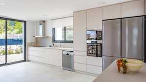 Eine moderne Küche mit Geschirrspüler, Backofen und einem Edelstahl-Kühlschrank.