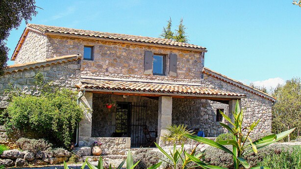 A stone house with a tiled roof, a porch, and a small garden. - Awesome home in Labeaume with WiFi (Labeaume)