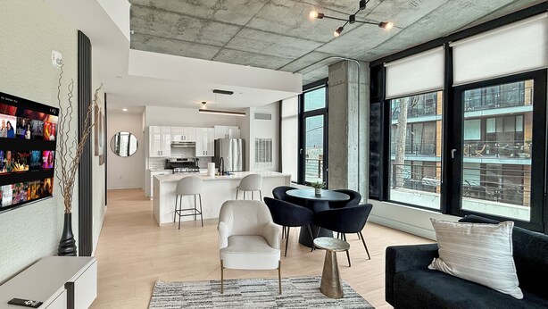 A modern living space with a kitchen, dining area, and seating. - Apartmint at N 2nd St Philadelphia (Philadelphia)