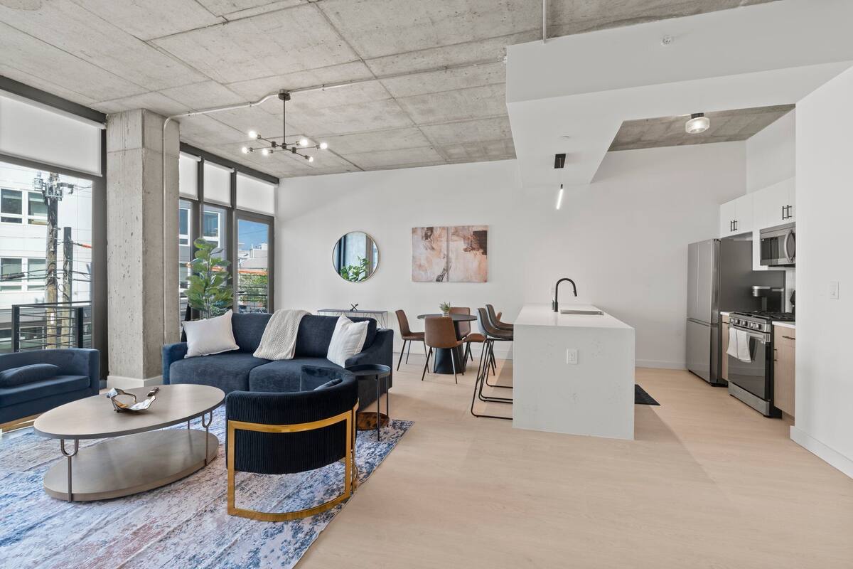 A modern apartment with a living area, dining space, and kitchen.