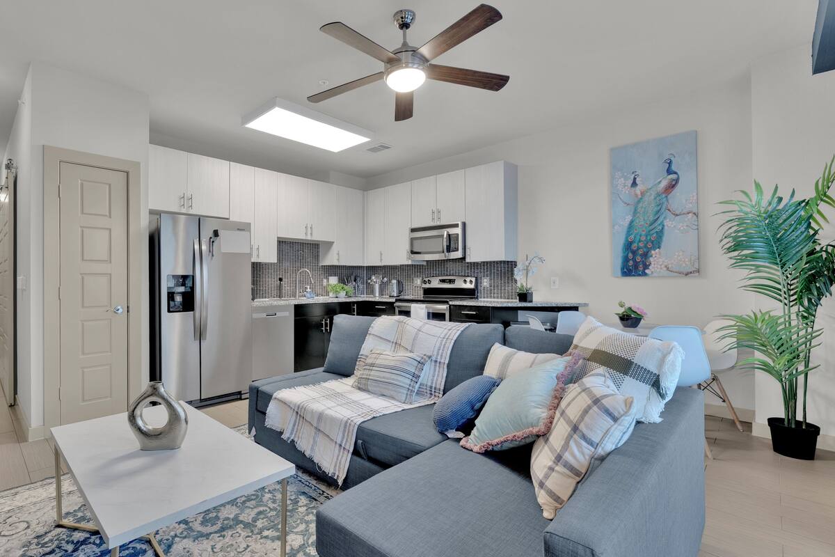 A modern kitchen with a refrigerator, microwave, and stove.