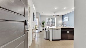 A modern kitchen with a central island, a built-in dishwasher, and a ceiling fan. - Apartmint at Bell Katy Trail Dallas (Dallas)