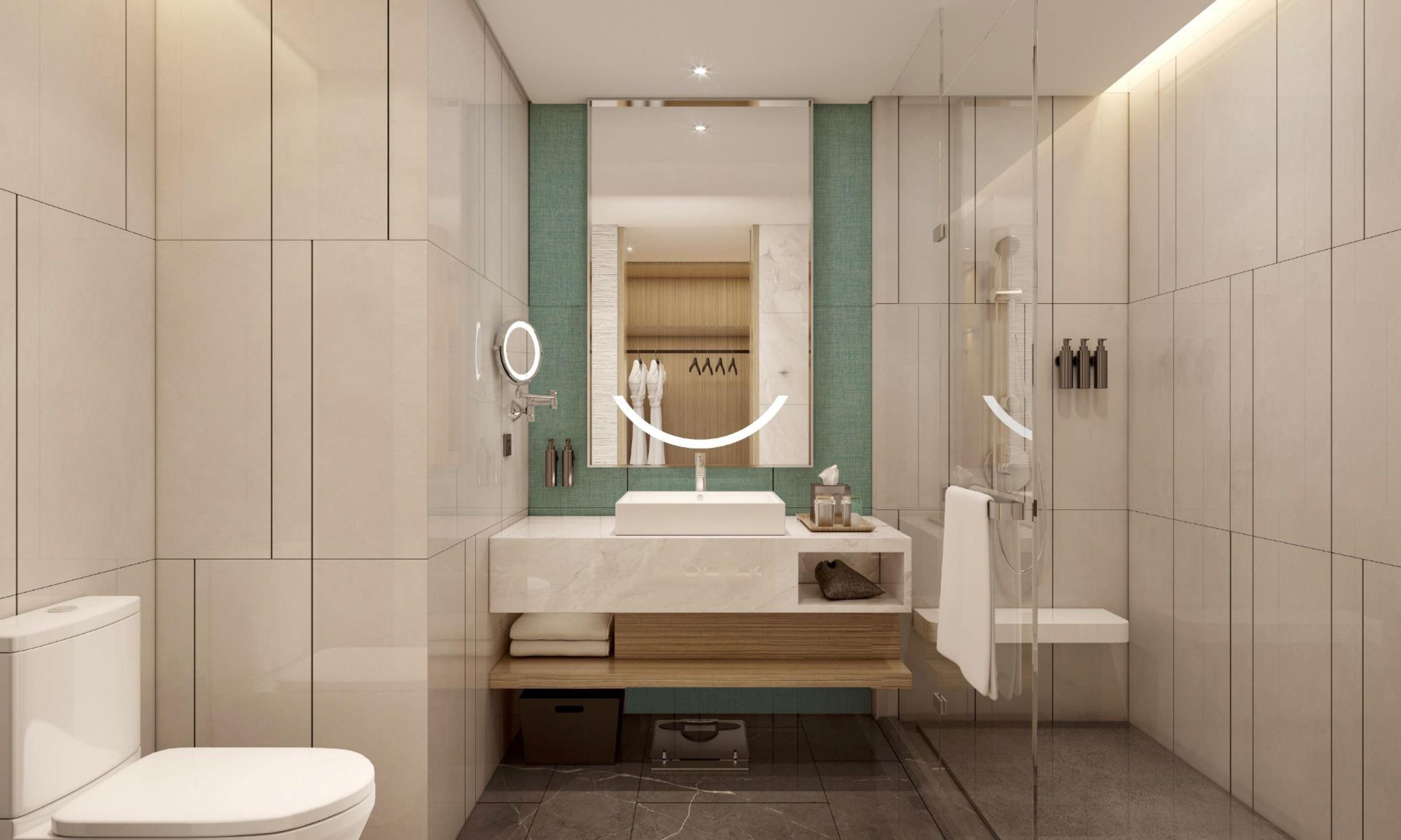 A modern bathroom with a toilet, sink, and shower area.
