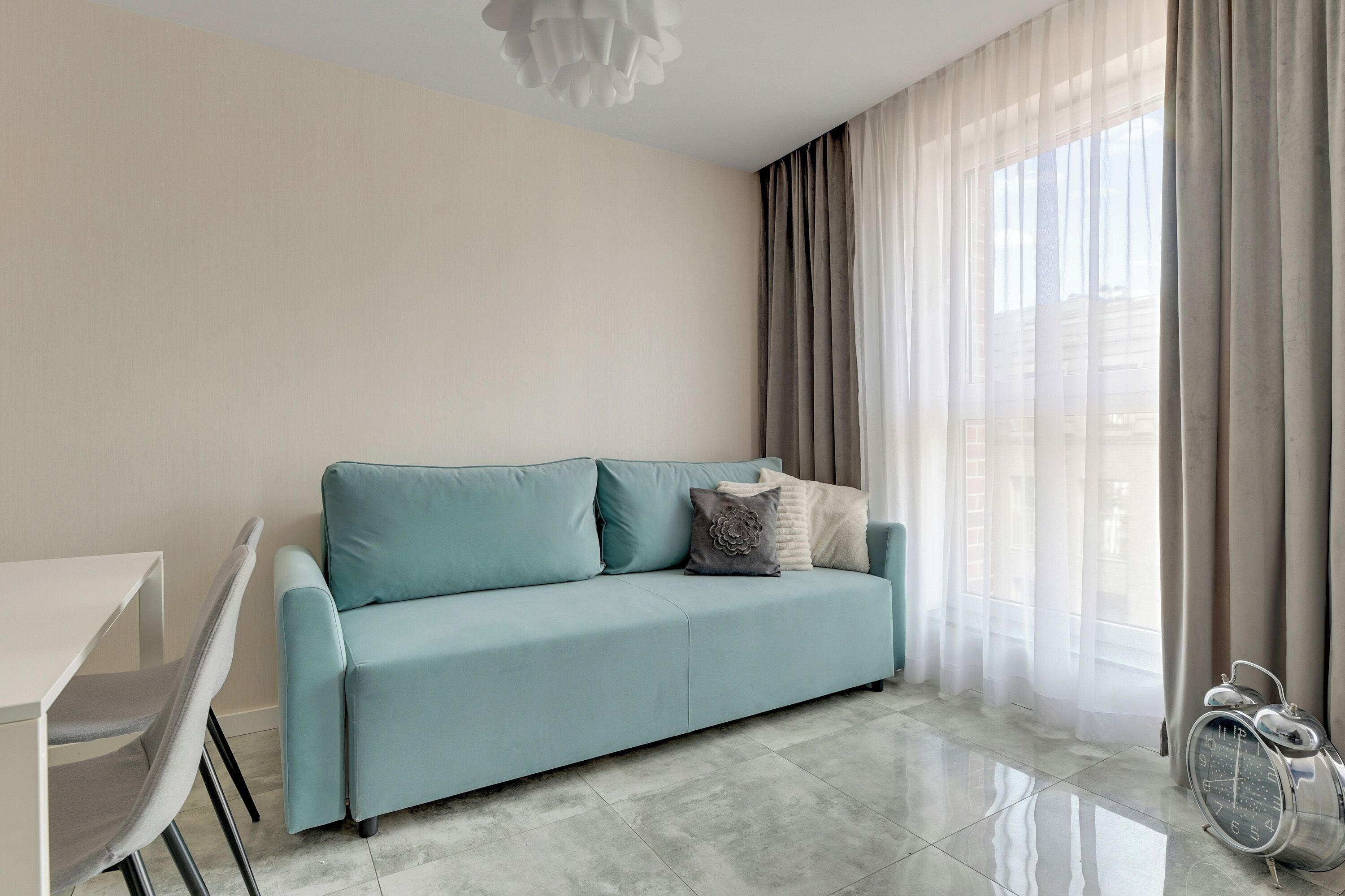 A modern living room with a sofa, a dining table, and a bicycle.