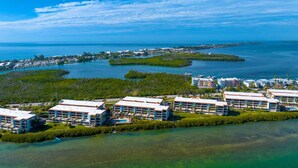 A coastal resort with multiple buildings, a marina, and clear blue waters. - Sandpiper Key Waterfront Views & Pool (Englewood)