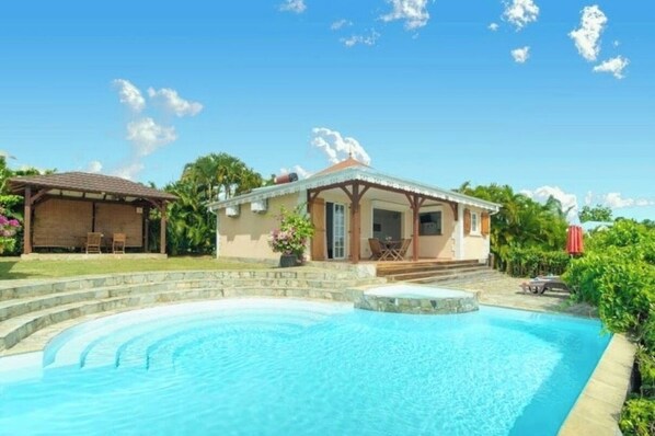 A house with a swimming pool, a patio, and a garden. - Vrbo Property (Sainte-Luce)