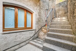 A stone staircase leading to a wooden-framed window with frosted glass. - Kirribilli House, Nago-Torbole, Italy (Nago-Torbole)