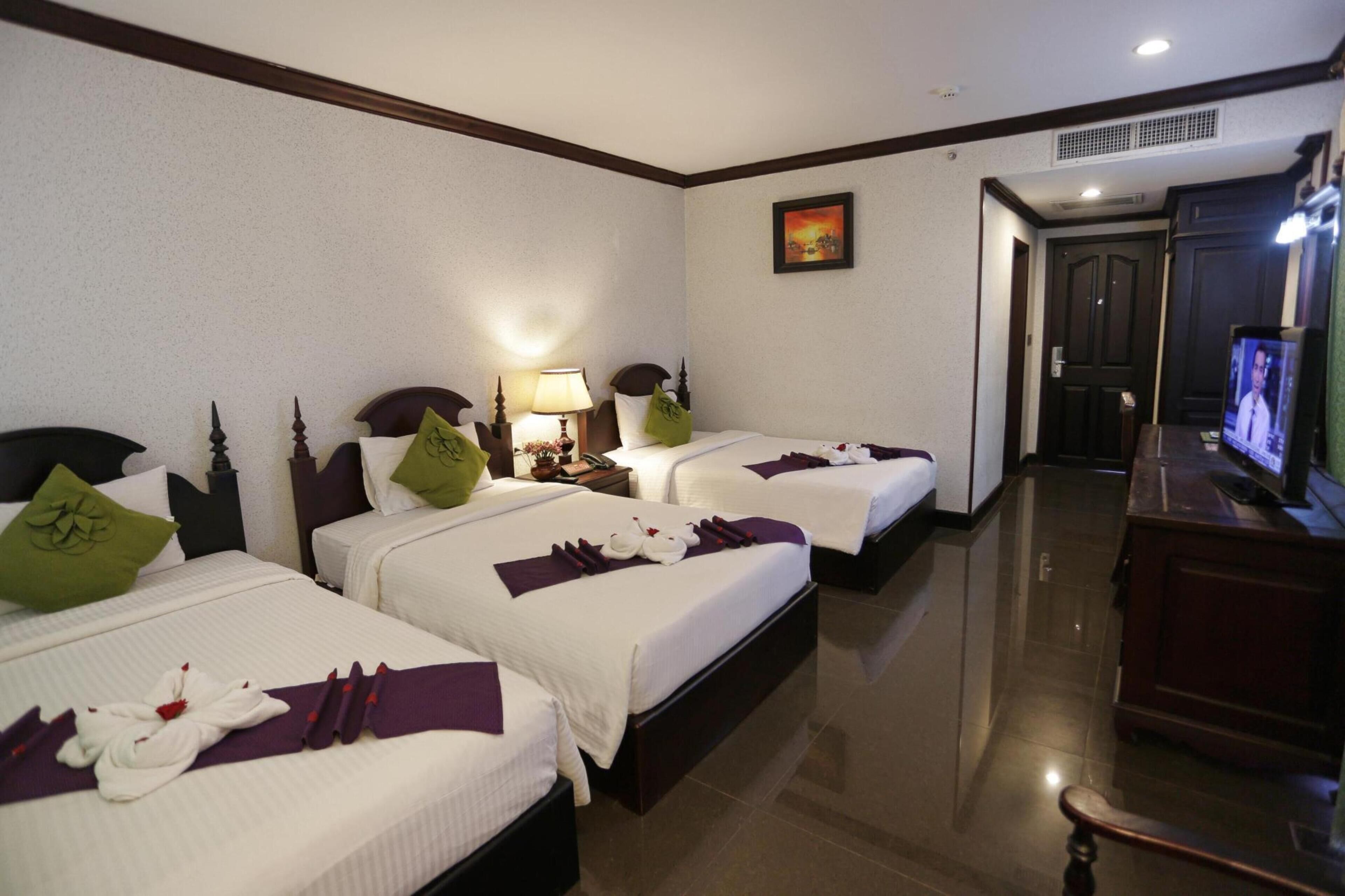 Family Triple Room, City View | In-room safe, desk, laptop workspace, blackout curtains