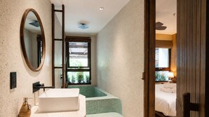A modern bathroom with a freestanding bathtub, a large mirror, and a window providing natural light. - Cam Ly The Boutique (Cam Ly - Da Lat)