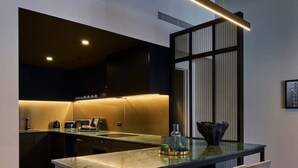 A modern kitchen with a central island, bar stools, and a pendant light. - The Grand Heritage Suite · 4 Bed · Entire Floor (Auckland City)