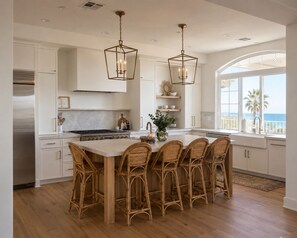 A modern kitchen with a central island, stainless steel appliances, and a large window overlooking the ocean. - Ocean View Retreat, Private Pool, Minutes to the Beach & Downtown Encinitas (Encinitas)