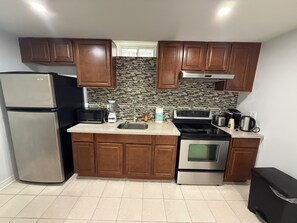 A kitchen with wooden cabinets, a refrigerator, a microwave, a stove, and a tiled backsplash. - Entire Privatesuite Separate Entrance Free Parking (Richmond Hill)