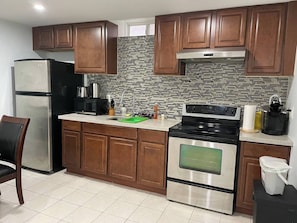 A kitchen with wooden cabinets, a stainless steel refrigerator, a microwave, a stove, and a tiled backsplash. - Entire Privatesuite Separate Entrance Free Parking (Richmond Hill)