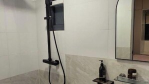 Un baño moderno con inodoro, lavabo y ducha.