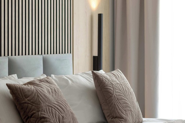 Bedroom details highlighting decorative cushions and elegant interior styling.