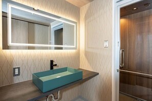 A bathroom with a rectangular sink, a mirror with a light, and a shower door. - JAPAVISTA Vita (BENTEN, MINATO WARD)