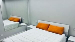 A hotel room with a bed, nightstands, a mirror, and a wall-mounted light switch. - S375 - Sirolo, three-room apartment with private courtyard (SIROLO)