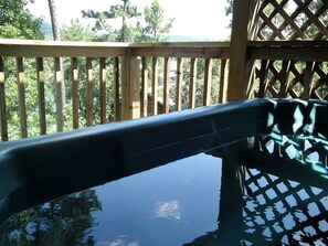 A wooden deck with a view of trees and mountains. - Serene Cottage with Pool, Jacuzzi and Lake Views in Mount Ida, Arkansas (Mount Ida)