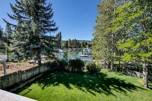 A marina with boats, a grassy area, and trees.