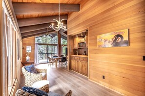 A wooden interior with a dining area, a chandelier, and a poster on the wall. - Spectacular Cabin with Foosball and Fireplace in Truckee, California (Truckee)
