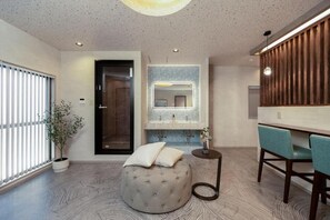 A modern bathroom with a round ottoman, a mirror, and a sink. - JAPAVISTA Zen (YOSHINO, FUKUSHIMA WARD)
