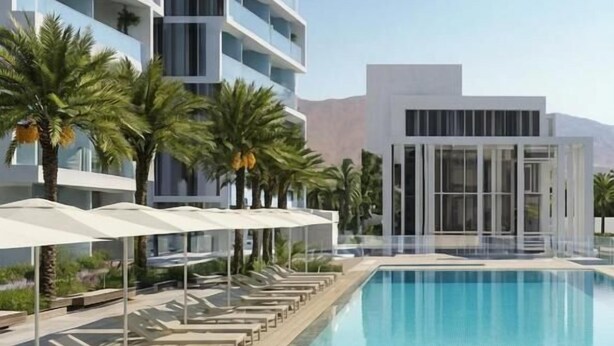 A modern hotel with a swimming pool, lounge chairs, and palm trees. - Ocean's Edge Suite at 42 Eilat (Eilat)