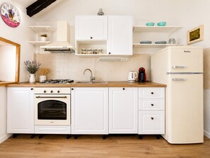 A kitchen with white cabinets, a stove, oven, sink, and a refrigerator. - Didini Dvori in Kru evo (Obrovac)