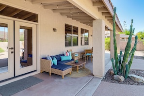 A covered patio area with a sofa, chairs, and a cactus. - Saguaro Sanctuary: Tucson Home w/ Outdoor Oasis (Tucson)