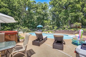 A backyard with a swimming pool, lounge chairs, a hot tub, and a barbecue area. - Gateway to St Louis: Group Getaway w/ Game Room (Florissant)