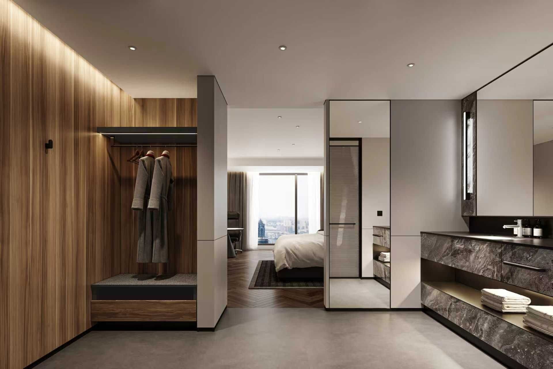 A modern hotel room with a wooden wardrobe, a bed with a city view, a bathroom with a marble vanity, and a large mirror.