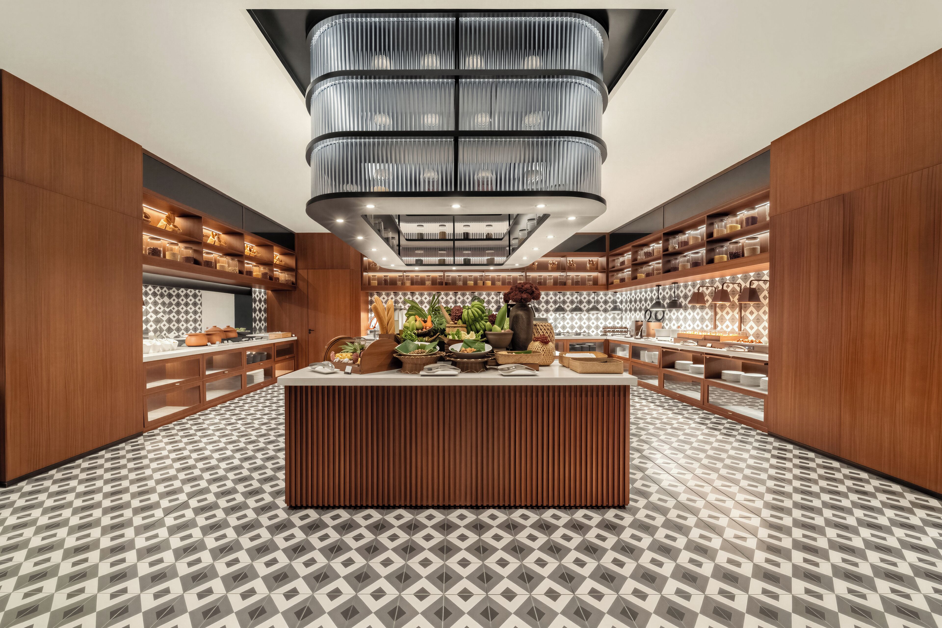 A modern kitchen with a central island, wooden cabinets, and a patterned floor.